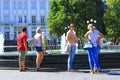 People enjoying weekend in city park near fountains. Family rest