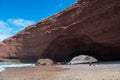 People enjpying beautiful day at Legzira beach with famous rock formation Royalty Free Stock Photo