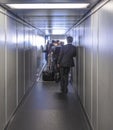 People enter the aircraft via a passenger bridge