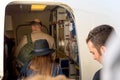 People entering airplane through door airport