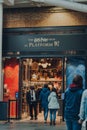 People entering Harry Potter shop by 9 three quarters platform inside King`s Cross station, London, UK Royalty Free Stock Photo