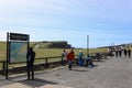 People at the entrance of the Cliffs of Moher, sea cliffs located at the southwestern edge of the Burren region in County Clare, I