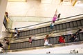 People on escalator moving up and down on each floor in shopping mall