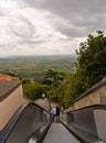People on escalator steps with Panoramic view of beautiful landscape from terrace park in Cortona, medieval town in Tuscany,