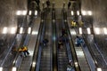 People on escalators in metro station, top view. Passengers crowd on escalators in subway