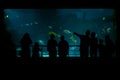 People on excursions in the aquarium in front of a large aquarium watch the underwater life of fish