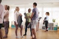 People In Exercise Clothing Meeting And Chatting Before Fitness Or Yoga Class In Community Center Royalty Free Stock Photo