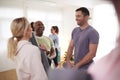 People In Exercise Clothing Meeting And Chatting Before Fitness Or Yoga Class In Community Center