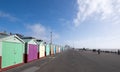 People exercising on Hove seafront near Brighton, UK, with colourful beach huts Royalty Free Stock Photo