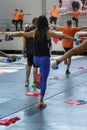 People Exercising with Plastic Water Bottle in Class at Gym with Music and Teacher on Stage