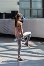 People Exercising with Plastic Water Bottle in Class at Gym with Music and Teacher on Stage