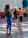 People Exercising with Plastic Water Bottle in Class at Gym with Music and Teacher on Stage