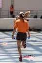 People Exercising with Plastic Water Bottle in Class at Gym with Music and Teacher on Stage