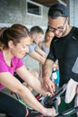 People exercising on stationary bikes in fitness class. Royalty Free Stock Photo