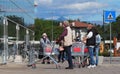 People with face mask and protective gloves waiting to enter the supermarket maintain the safety distance