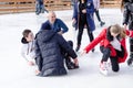 Izmail, Ukraine - February, 15, 2020: people fall on an ice rink. Ice skating.