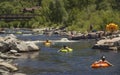 People families having fun cooling off floating in inflatable tubes down the San Juan River on hot summer day in Pagosa Spring