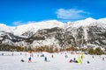 People having fun and learning how to ski and snowboard on El Tarter green slops, Andorra