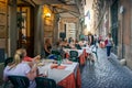 People and families sitting in outdoor dinning area in Italian restaurant