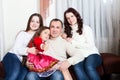 People family, christmas and adoption concept - happy mother, father and children hugging near a Christmas tree at home Royalty Free Stock Photo