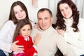 People family, christmas and adoption concept - happy mother, father and children hugging near a Christmas tree at home Royalty Free Stock Photo