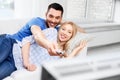 Happy smiling couple watching tv at home Royalty Free Stock Photo