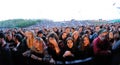 People (fans) scream and dance in the first row of a concert at Heineken Primavera Sound 2013 Festival