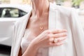 People, fashion, jewelry and luxury concept, closeup of woman wearing luxury jewelry standing near expensive car on the Royalty Free Stock Photo