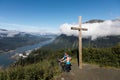 People at Father Brown's Cross, Mount Roberts with view of Juneau, Alaska in the background