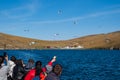 People feed seagulls from the ferry. Baikal Lake in autumn. Strait Olkhonskie Vorota and regular passenger ferry to the