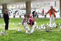 People feeding birds in the park