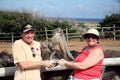 People feeding ostrich at aruba ostrich farm