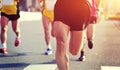 People feet on city road in marathon running race