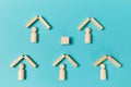 People figures under houses roofs mockup style, place for text. Empty wooden cube. Template for creative design on blue