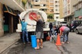 People fill containers with water from truck tanker delivery by major municipalities hydrant during COVID-19 quarantine