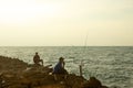 People are fishing alone in the sea. Fishing is one of the most popular hobbies