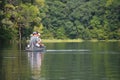 People fishing from canoe on lake