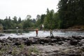 People fishing on the river bank