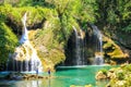 People fishing in Semuc champey natural pool, waterfall and rocks from riverside