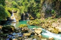 People fishing in Semuc champey natural pool, waterfall and rocks from riverside
