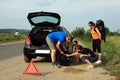 People fixing a flat tire