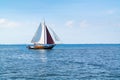 People on flatbottom sailboat sailing on Waddensea near island T