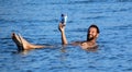 People floating in the salty water of the dead sea