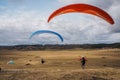 people flying on paraplanes in field with clouds on sky Ukraine Crimea Royalty Free Stock Photo