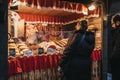 People at a food stand at Stephansplatz Christmas Market in Vienna, Austria.