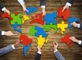 People Forming World Map with Puzzle Pieces Royalty Free Stock Photo