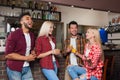 People Friends Drinking Orange Juice Talking Laughing Sitting At Bar Counter, Mix Race Man And Woman Couple Royalty Free Stock Photo