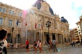 People in front of the Baroque town-hall in Cartagena Spain