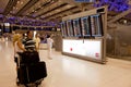 People in front of departures board of airport Royalty Free Stock Photo