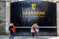 People in front of the historic old factory building wooden gate entrance at Guinness St. JamesÃÂ´s Gate Brewery in Dublin. Royalty Free Stock Photo